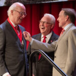 Charlie Stallings (left) receives his Watauga Medal from Chancellor Randy Woodson and Ed Weisiger Jr.