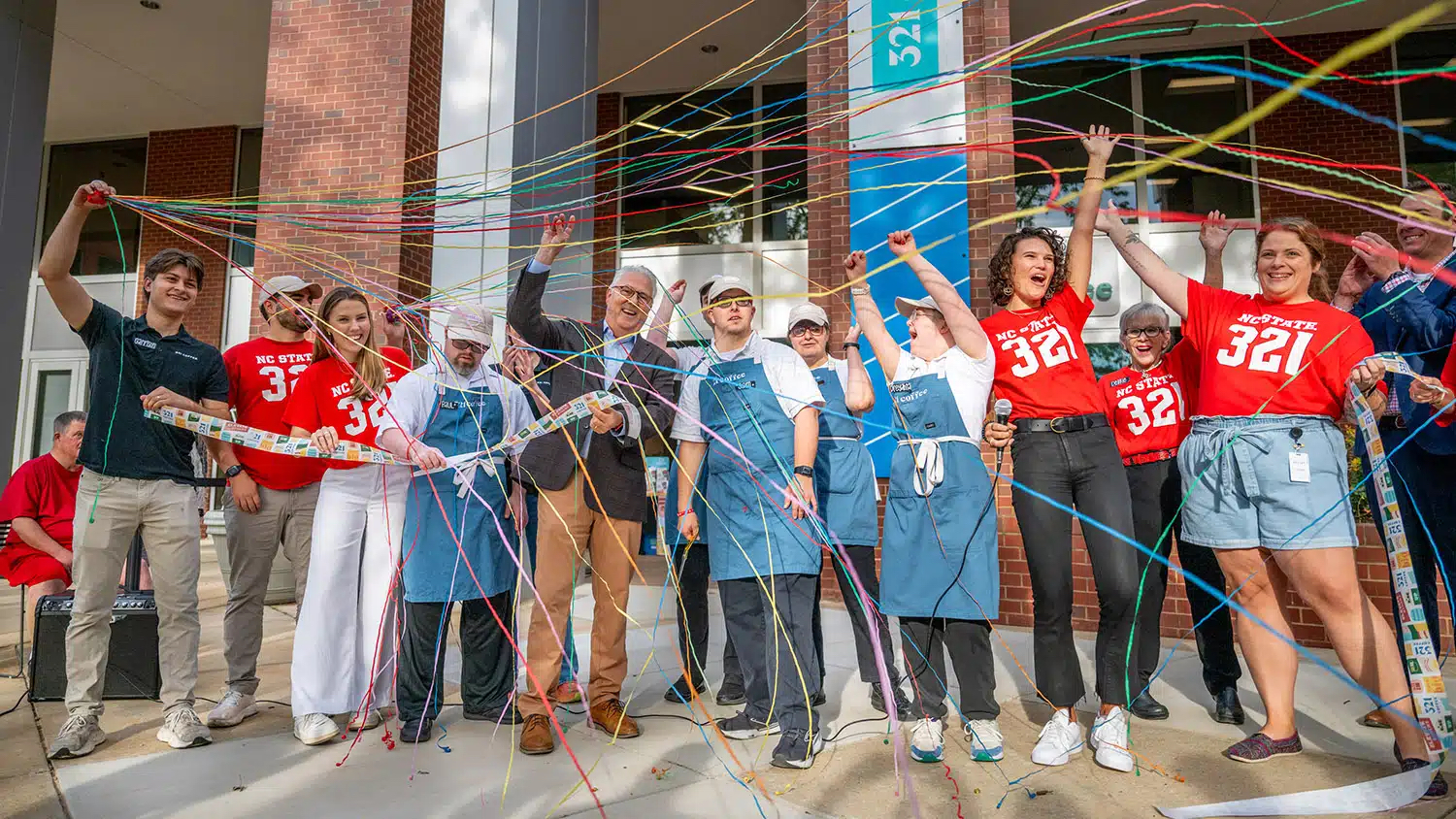 The 321 Coffee team and Chancellor Woodson cut the ribbon on the new Centennial Campus location.