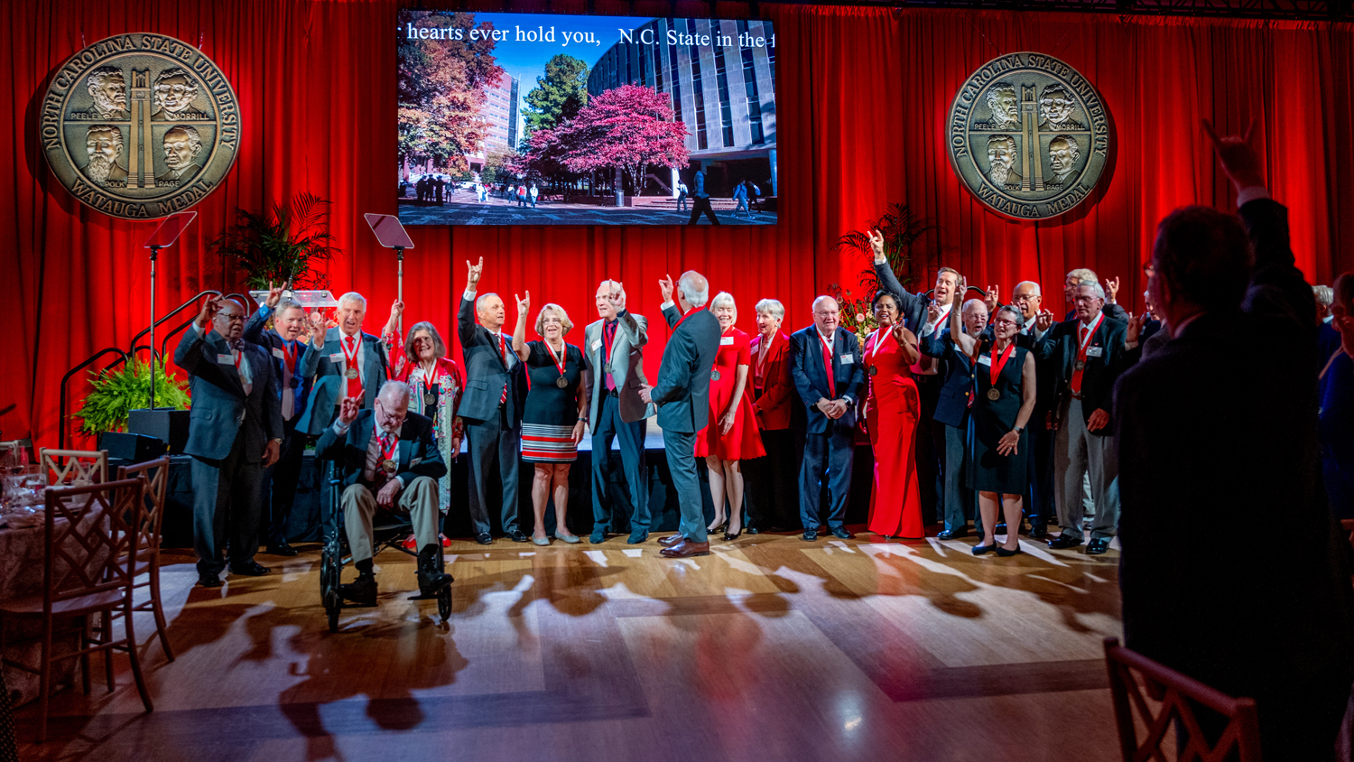 New and previous recipients of the Watauga Medal sing the NC State alma mater during the 2024 award ceremony.