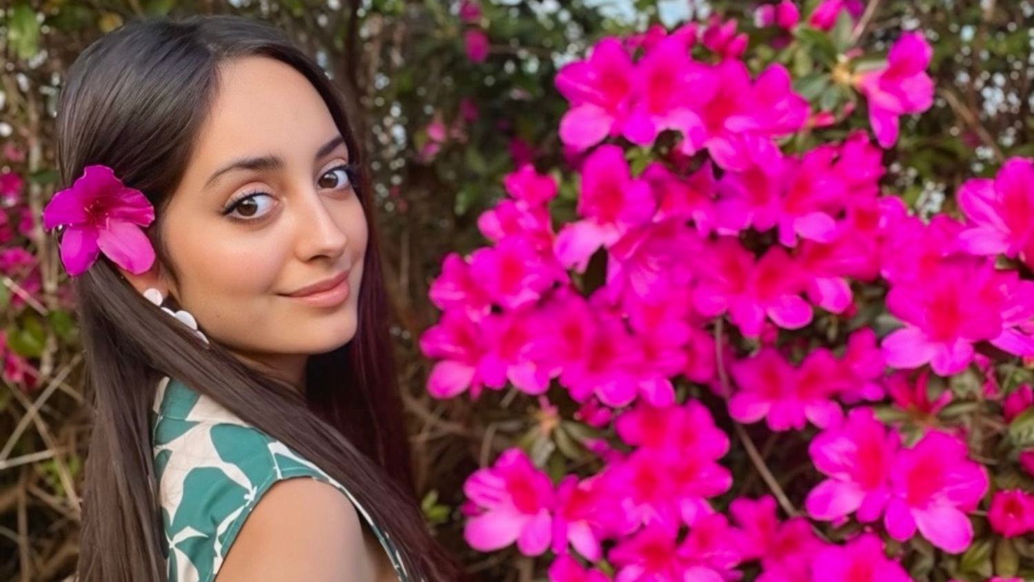 Camilla Torres standing next to flowers