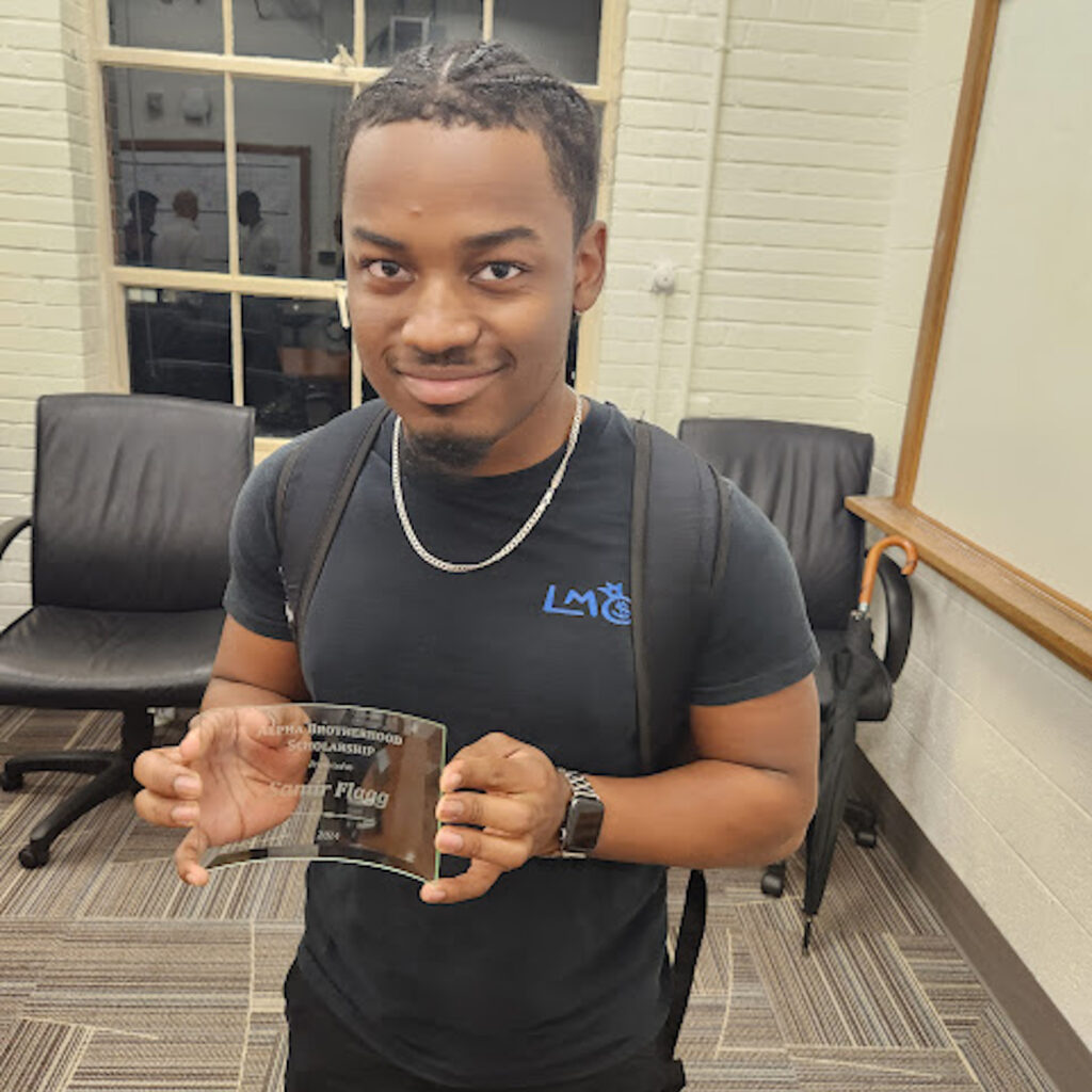 Samir Flagg with his Alpha Brotherhood Scholarship award. Photo provided.