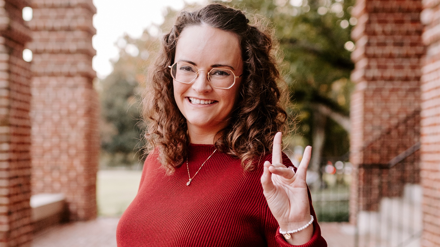 Meredith Martinez holding up the NC State wolf hand sign.