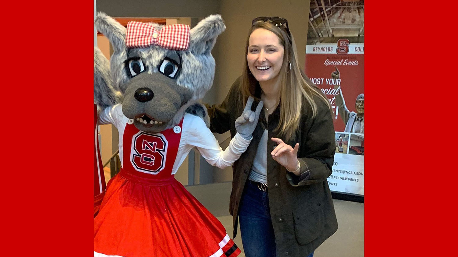 Jackie Collins and Ms. Wuf holding up the wolfie hand sign