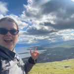 Sarah Simmons ’25, recipient of the Ronald and Dale Terry Student Assistance and Enrichment Fund, holds up the wolfie hand sign during her 2023 study-abroad experience in the Arctic Circle.
