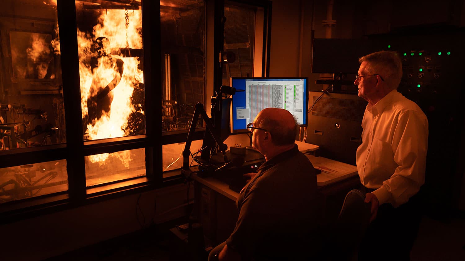 Burlington Distinguished Professor Roger Barker (right), founder and director of the newly named Milliken Textile Protection and Comfort Center, works with John Morton-Aslanis, research scholar and thermal lab manager, to conduct a test using PyroMan™, a life-size manikin designed to evaluate the performance of thermal protective clothing.