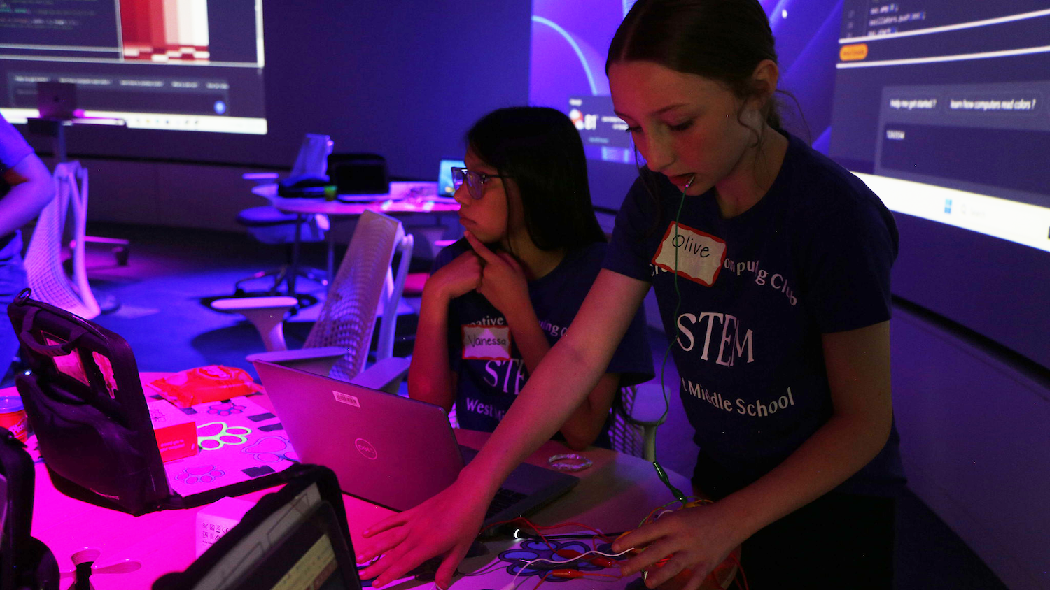 Sixth grader Olive Cleckler shows off her discovery making a circuit kit with her braces during the Creative Computing Showcase at NC State's Hunt Library.