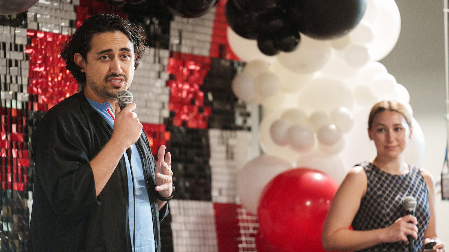 Two people holding microphones.