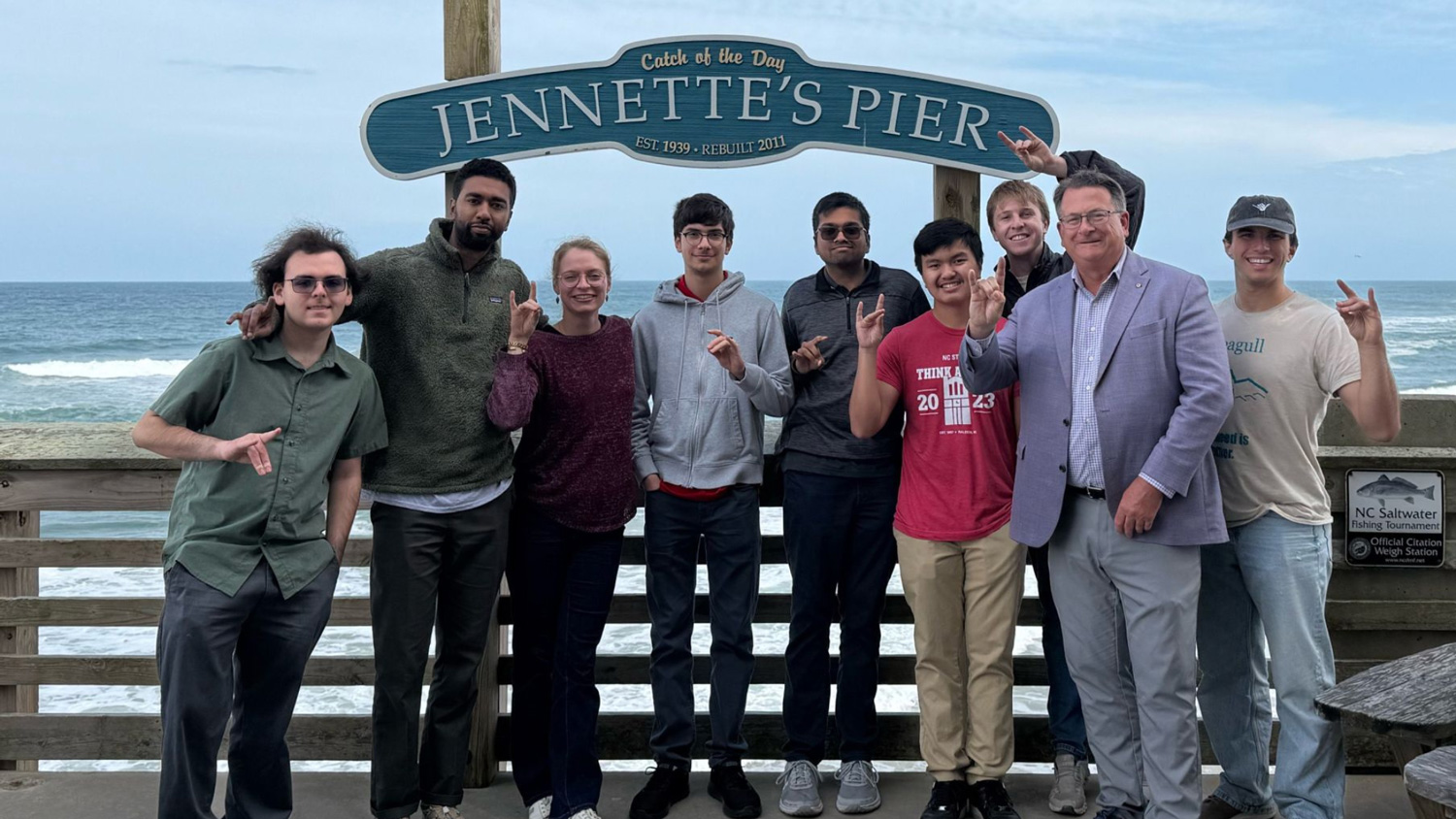 Members of the Albright Entrepreneurs Village stand in front of the Jennette’s Pier sign on North Carolina’s Outer Banks.