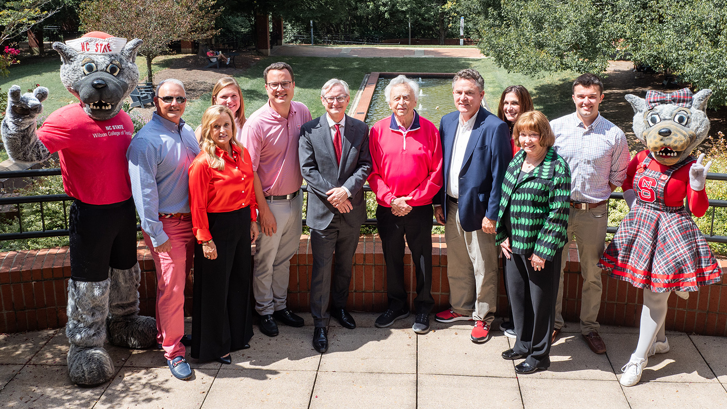 The Wilson family, Dean Hinks and the Wufs pose outside at the college