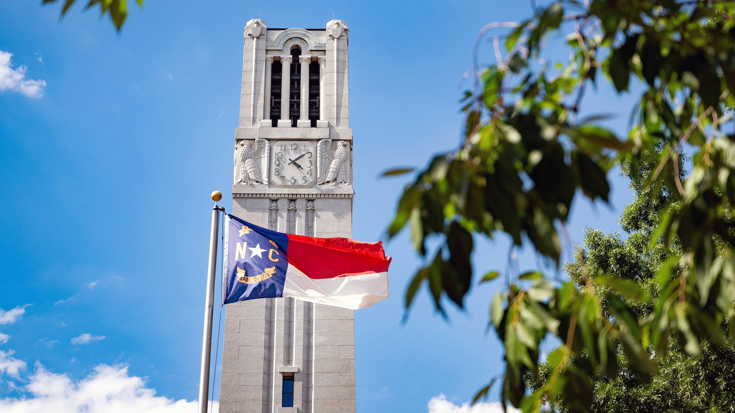 The North Carolina flag in front of the Memorial Belltower.